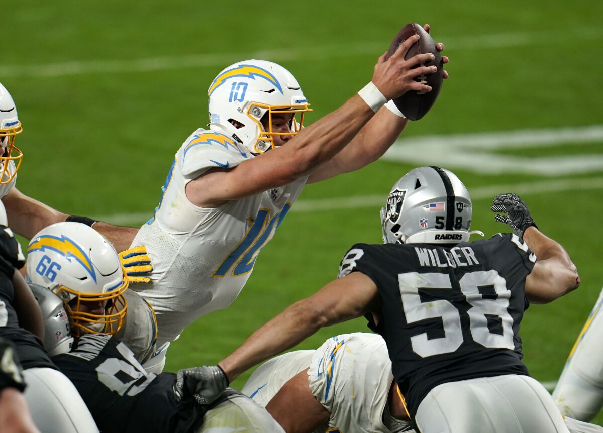 Chargers quarterback Justin Herbert scores the game-winning touchdown in overtime against the Las Vegas Raiders.