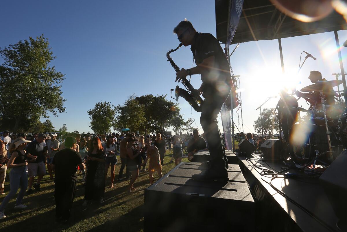 Sax player Richard "Tyzzy" Tyznick of the Family Style band plays at Costa Mesa's Concerts in the Park series Tuesday.