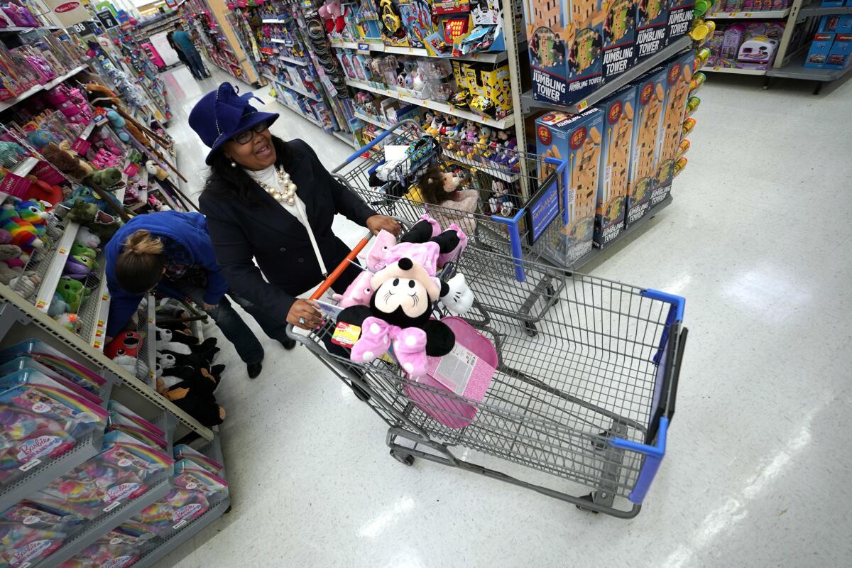 Walmart shoppers make their way through the toy aisles in Houston.