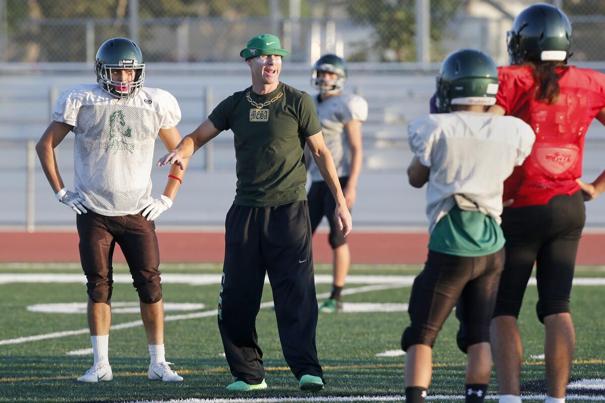 Coach Jimmy Nolan, center, seen giving instructions during Costa Mesa's practice on Monday, guided the Mustangs to a 21-18 win over Santiago at Garden Grove High on Friday.