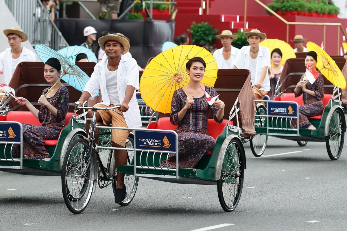 SINGAPORE - AUGUST 09: The Singapore Airlines vintage contingent march past during the National Day Parade at Padang on August 9, 2015 in Singapore. Singapore is celebrating her 50th year of independence on August 9, 2015. (Photo by Suhaimi Abdullah/Getty Images) ** OUTS - ELSENT, FPG - OUTS * NM, PH, VA if sourced by CT, LA or MoD **