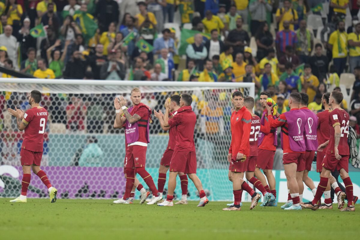 Serbia's players leave the pitch at the end of the World Cup group G soccer match between Brazil and Serbia, at the Lusail Stadium in Lusail, Qatar, Thursday, Nov. 24, 2022. (AP Photo/Aijaz Rahi)