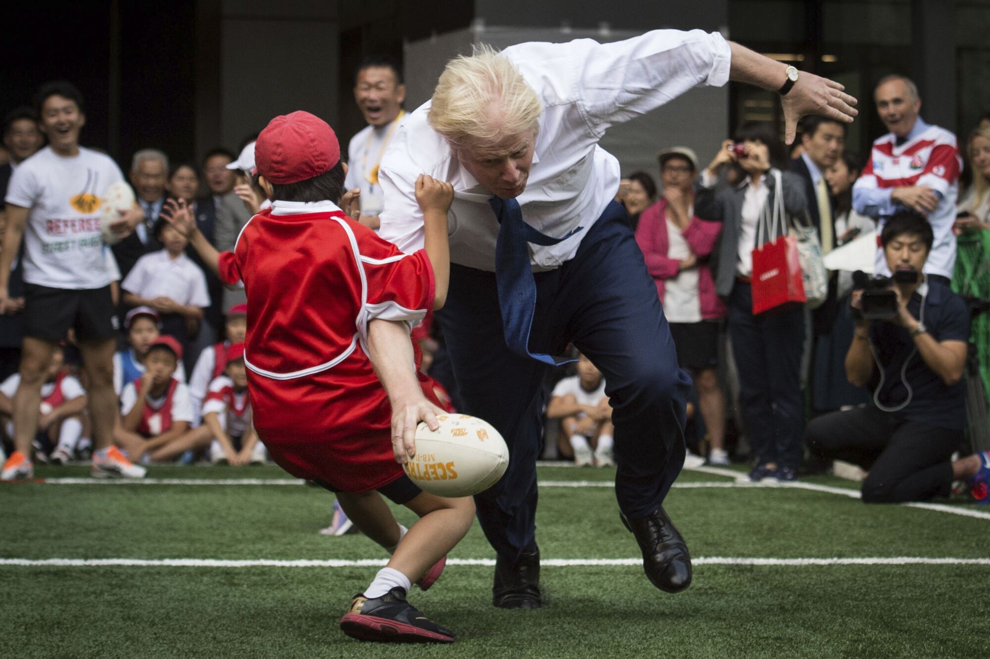 Boris Johnson takes part in a street rugby tournament on the streets of Tokyo.  15, 2015.
