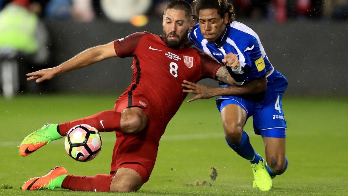 Clint Dempsey fires a shot, and scores, while under pressure from Honduras defender Henry Figueroa during their World Cup qualifier on Friday night. (Sean M. Haffey / Getty Images)