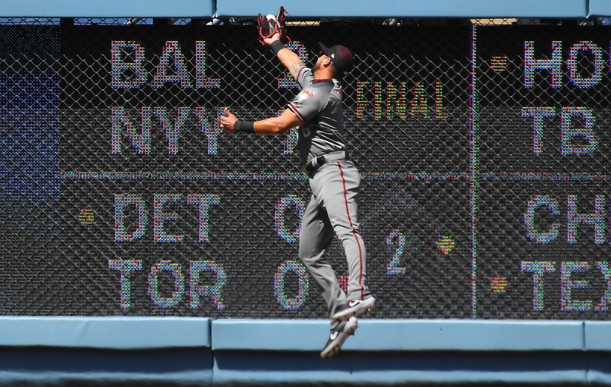 Arizona Diamondbacks left fielder David Peralta leaps but can't catch a first-inning double by Joc Pederson during Thursday's game.