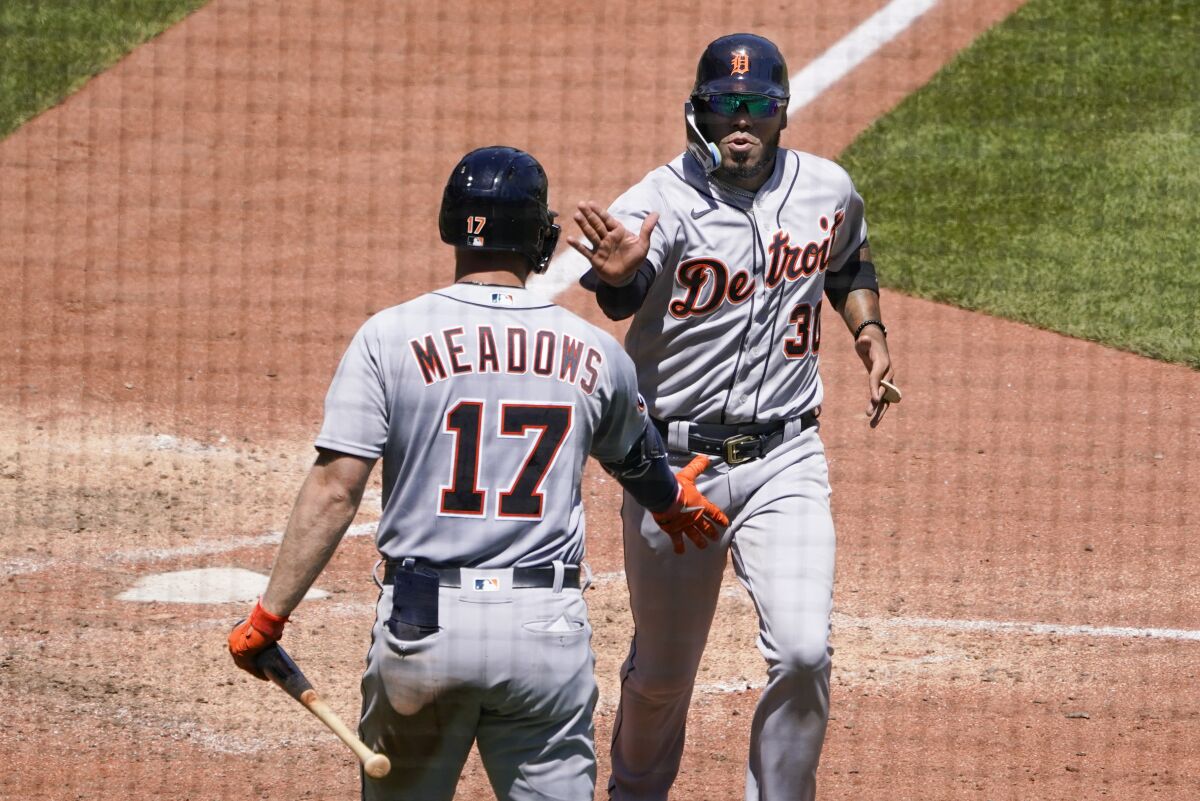 Detroit Tigers' Harold Castro, right, is greeted by Austin Meadows (17) after scoring against the Pittsburgh Pirates on a single by Miguel Cabrera during the eighth inning of a baseball game, Wednesday, June 8, 2022, in Pittsburgh. (AP Photo/Keith Srakocic)