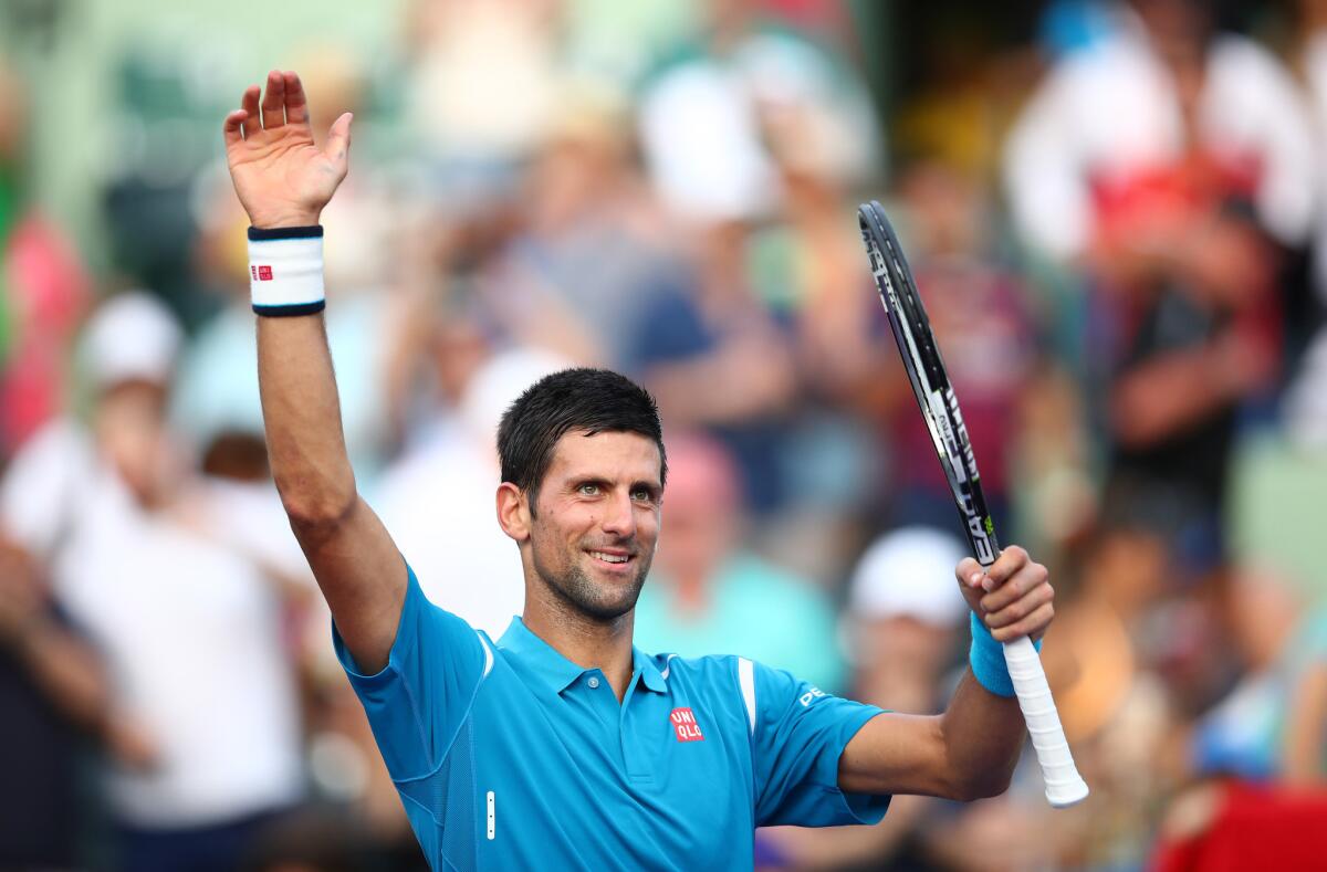 Novak Djokovic celebrates to the crowd after his straight sets victory against Joao Sousa in their third round match during the Miami Open.