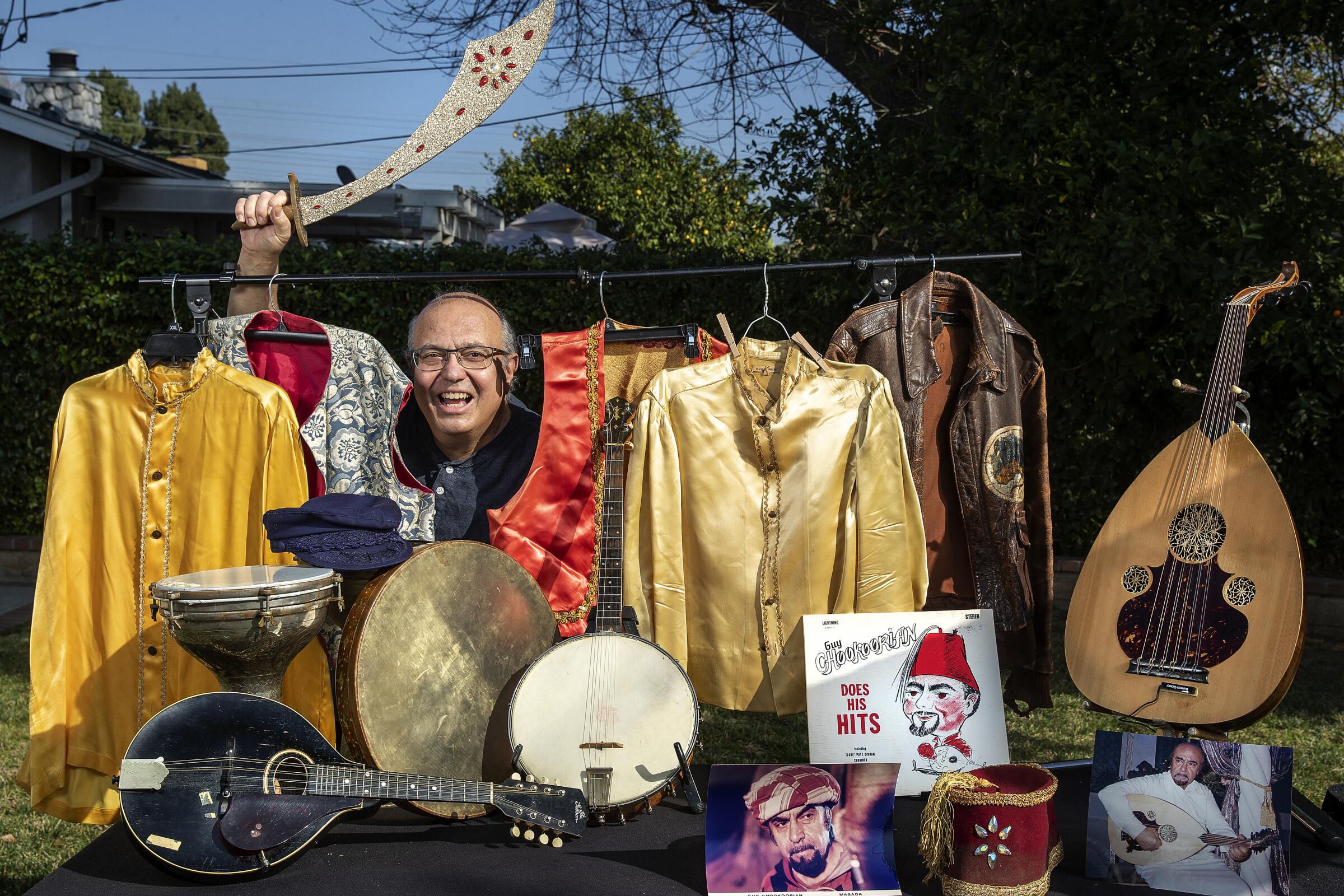 Arshag Chookoorian at home in Northridge with memorabilia that belonged to his dad, musician and actor Guy Chookoorian.