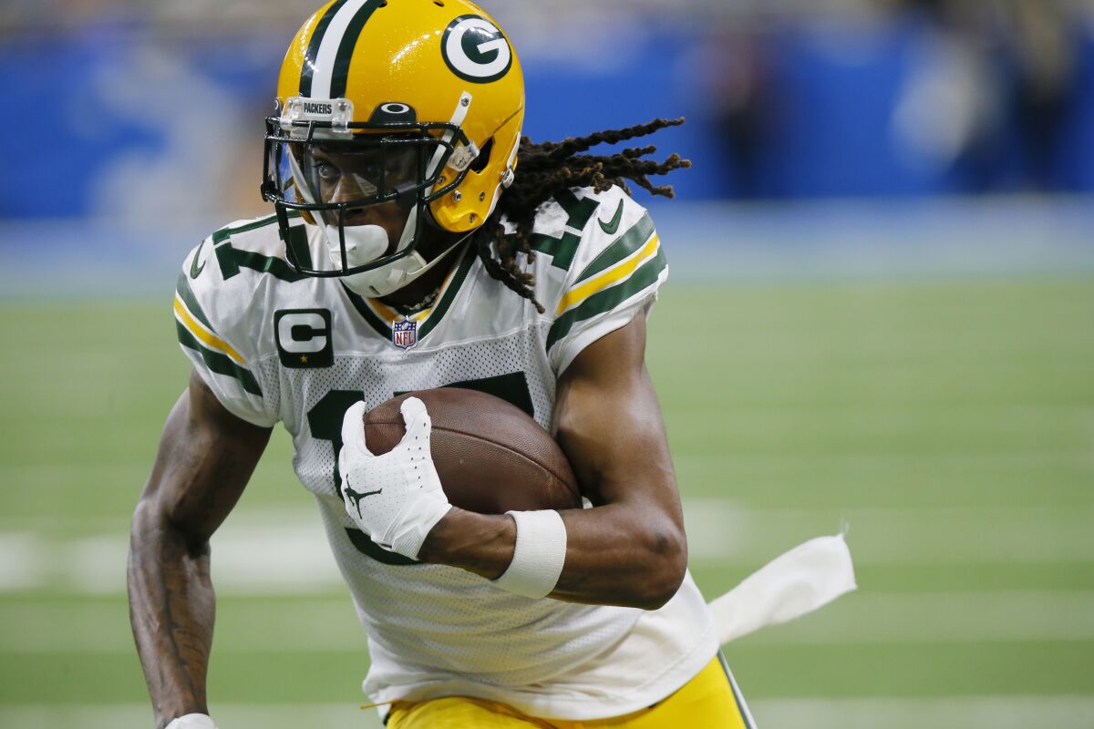 FILE - Green Bay Packers wide receiver Davante Adams runs during the first half of the team's NFL football game against the Detroit Lions on Jan. 9, 2022, in Detroit. The Las Vegas Raiders have traded two draft picks to Green Bay for All-Pro receiver Adams. A person familiar with the move said Thursday, March 17, the Raiders are sending the No. 22 overall pick in April's draft and another draft pick to the Packers to reunited Adams with his college quarterback Derek Carr. The person spoke on condition of anonymity because the deal hadn't been announced. (AP Photo/Duane Burleson, File)