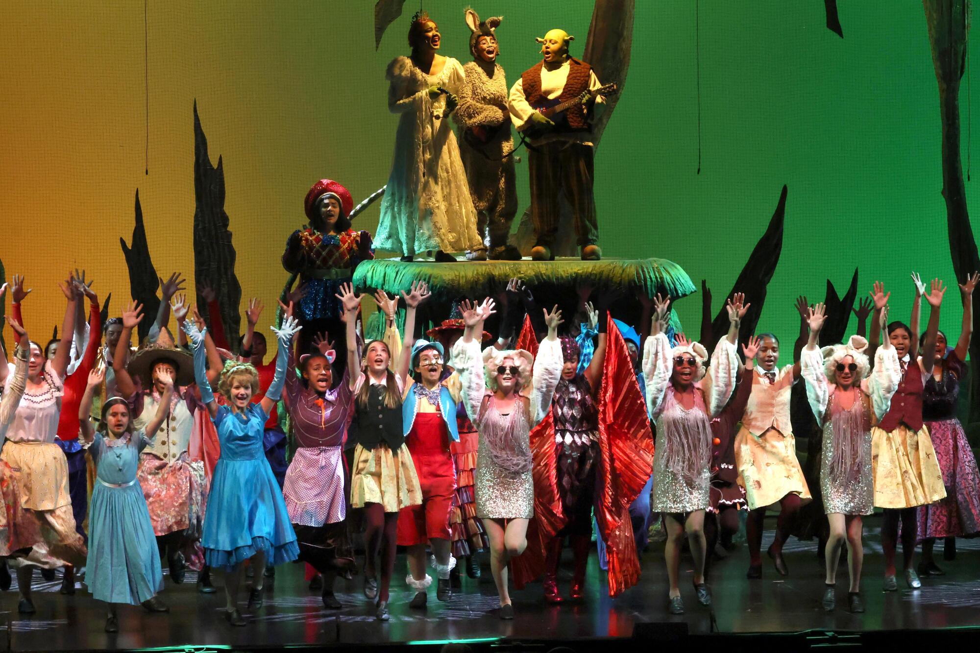 Altadena and Eliot Arts magnet performers successful colorful costumes execute "Shrek the Musical Jr." astatine the Ahmanson Theatre.