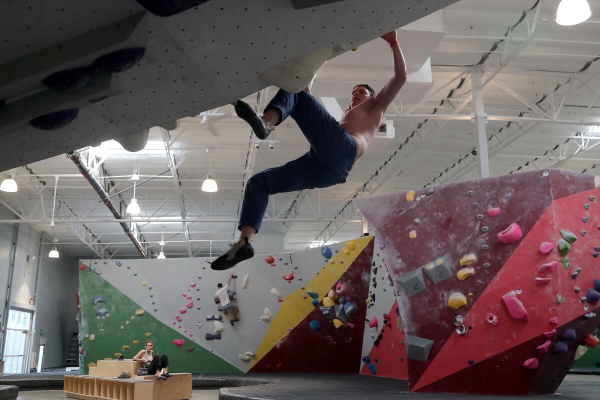 Keaton Lewis, 23, climbs a roof wall at Movement in Fountain Valley on Wednesday.