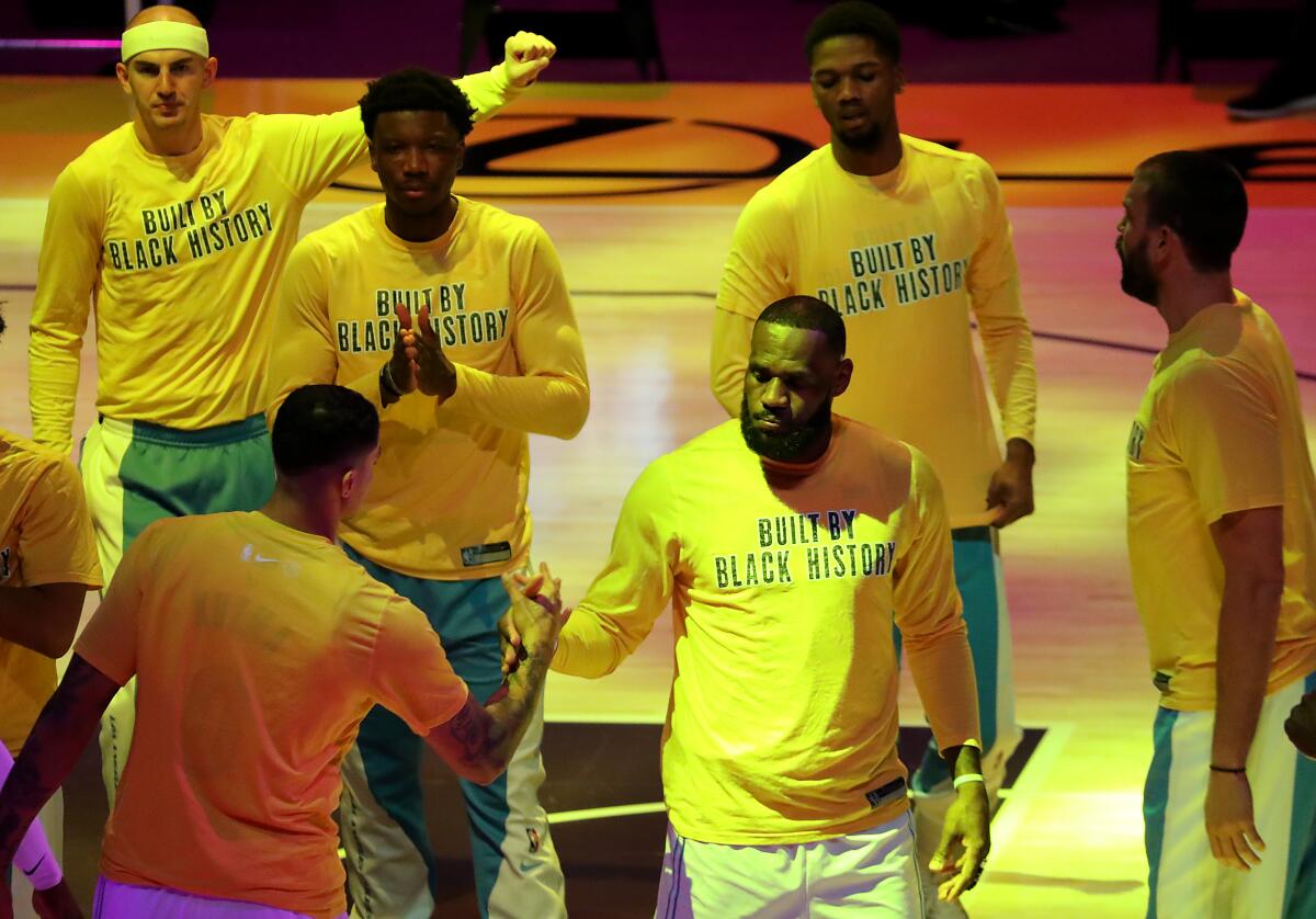 LeBron James and Kyle Kuzma exchange handshakes before a game against the Wizards on Feb. 22.