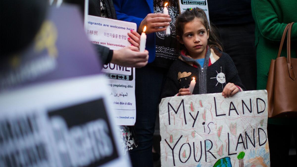 Maya Casillas, 7, joins a protest at Los Angeles City Hall against President Trump's executive orders on immigration.
