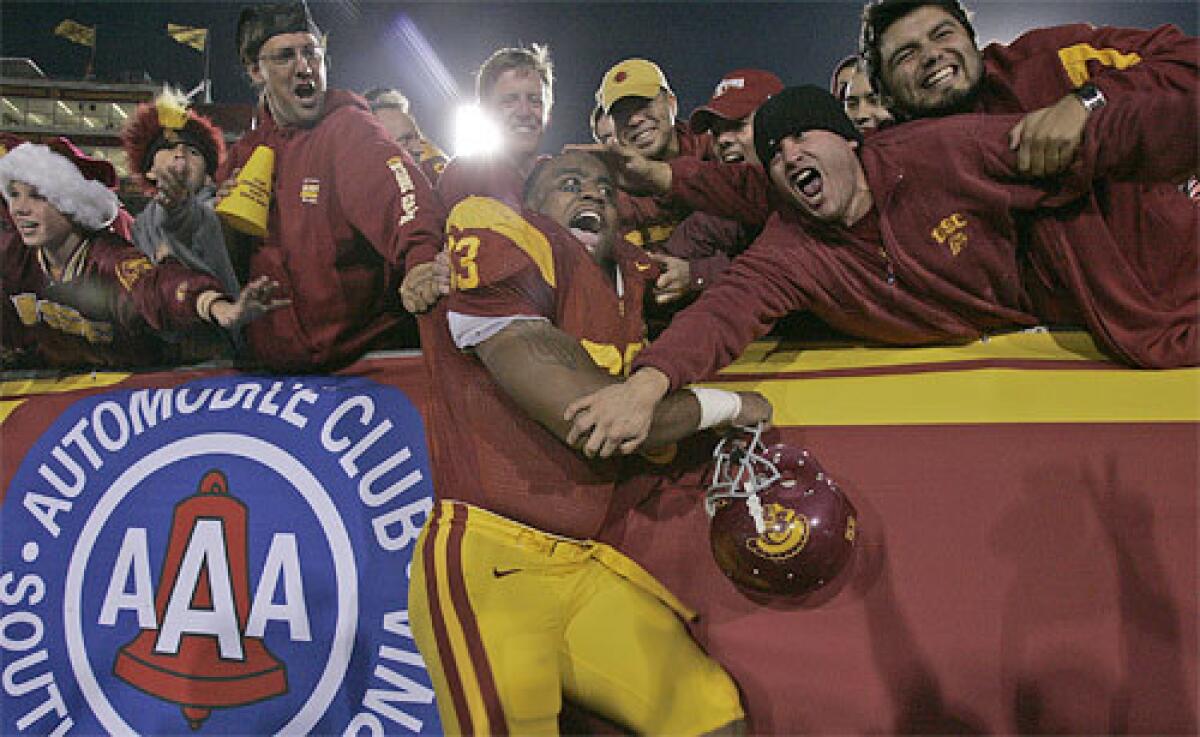 USC defensive end Everson Griffen celebrates with fans.