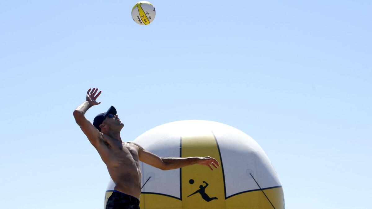 Phil Dalhausser serves the ball during the men's finals of the AVP Manhattan Beach Open last year.