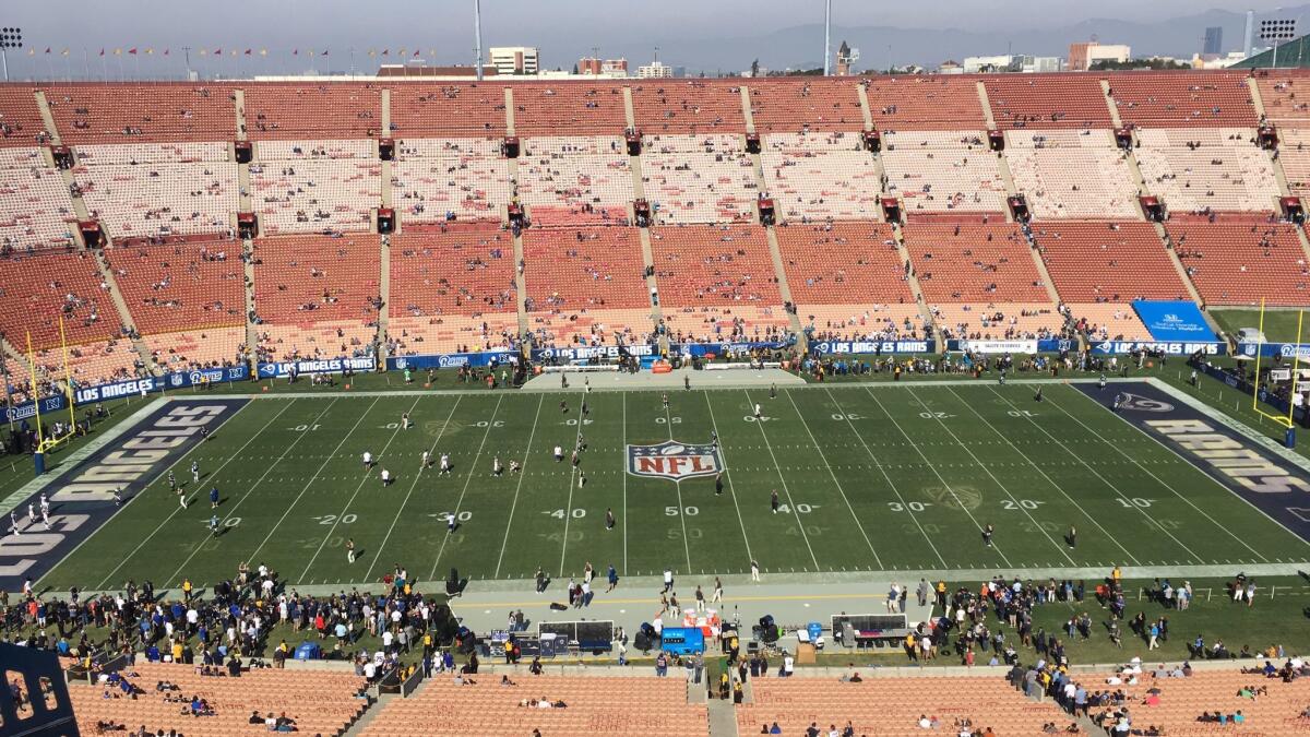 Pac-12 logos and hash marks from USC's victory over Oregon on Saturday were still visible on the field before the Rams hosted the Panthers on Sunday.