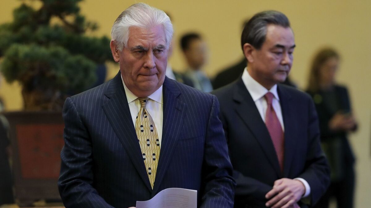 Secretary of State Rex Tillerson, left, and Chinese Foreign Minister Wang Yi arrrive for a joint news conference at Diaoyutai State Guesthouse in Beijing.