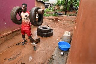 Gayaza, Uganda April , 2023-Dennis Kazumba works out with an old tires outside his home in Guyaza, Uganda.