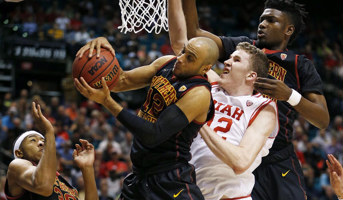 USC guard Julian Jacobs tries to pull down a rebound against Utah forward Jakob Poeltl during a Pac-12 tournament game Thursday.