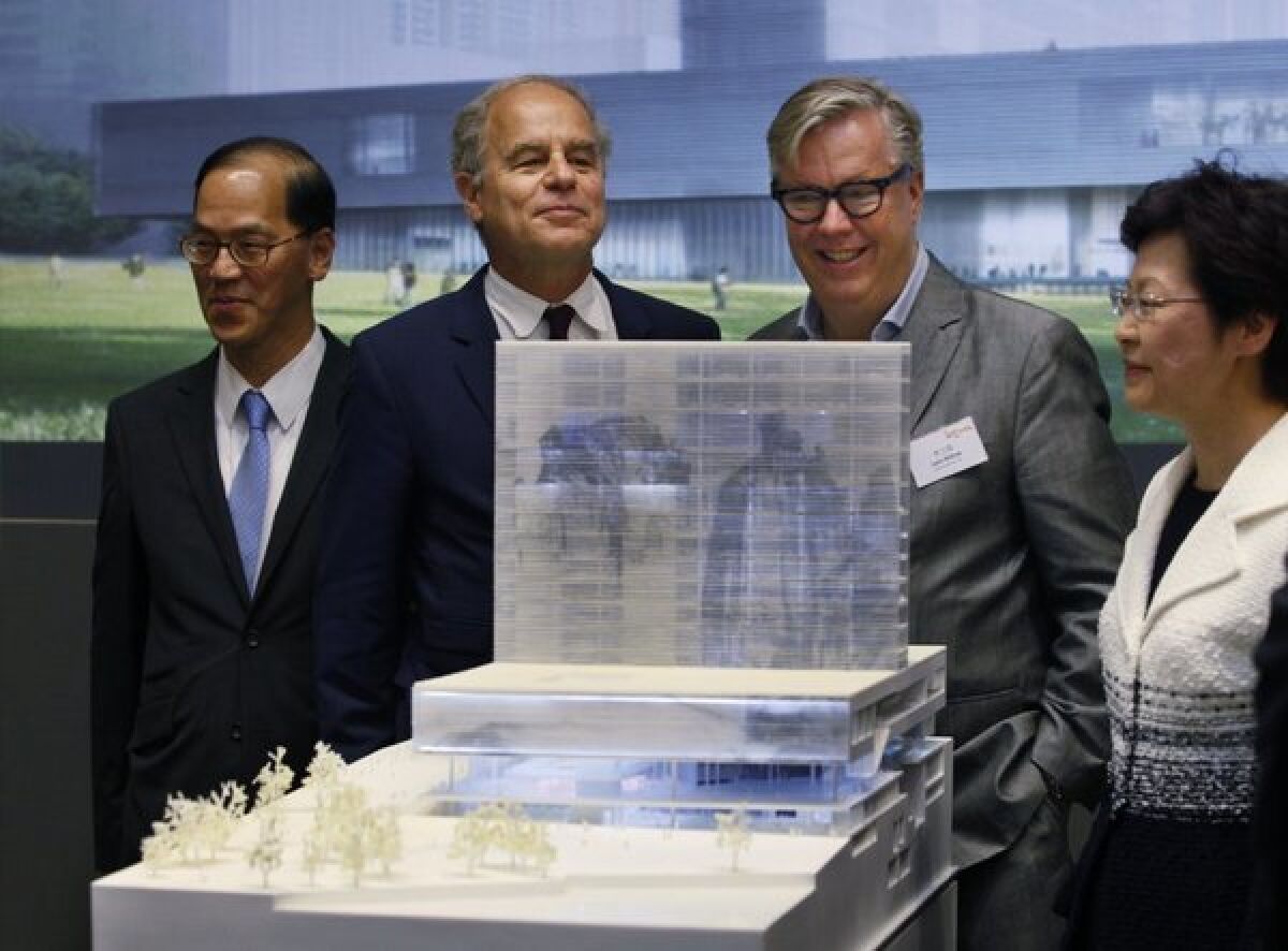 Hong Kong Secretary for Home Affairs Tsang Tak-sing, left, architect Pierre de Meuron, cultural district Executive Director Lars Nittve and Hong Kong Chief Secretary Carrie Lam with a model of M+ museum in Hong Kong.