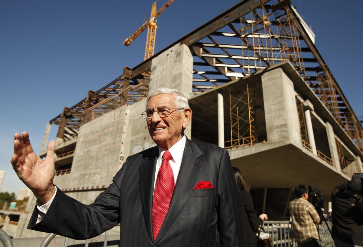 Eli Broad stands before the steel-and-concrete frame of the Broad museum before its completion.