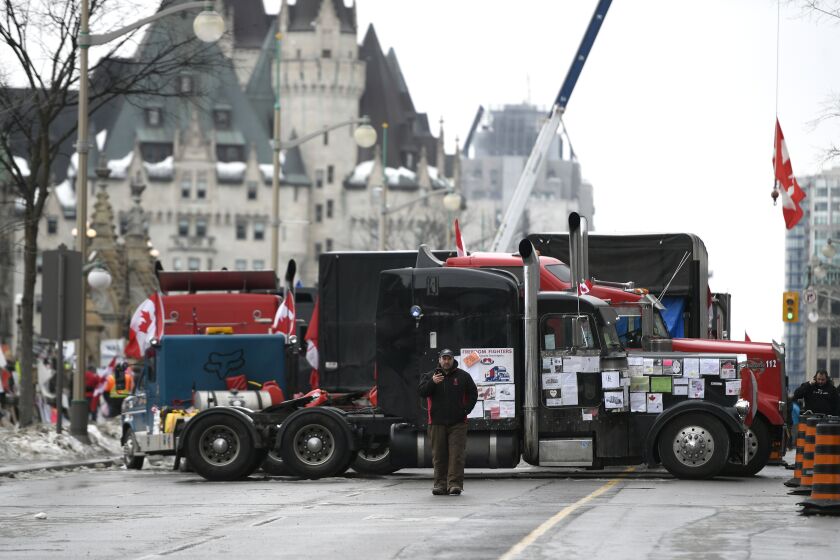 Trucks, are parked in front of the Chateau Laurier as a protest against COVID-19 restrictions continue in Ottawa, Thursday, Feb. 10, 2022. (Justin Tang /The Canadian Press via AP)