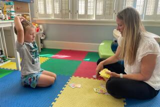 Kate Gawlik of The Ohio State University College of Nursing plays a game with one of her four children.