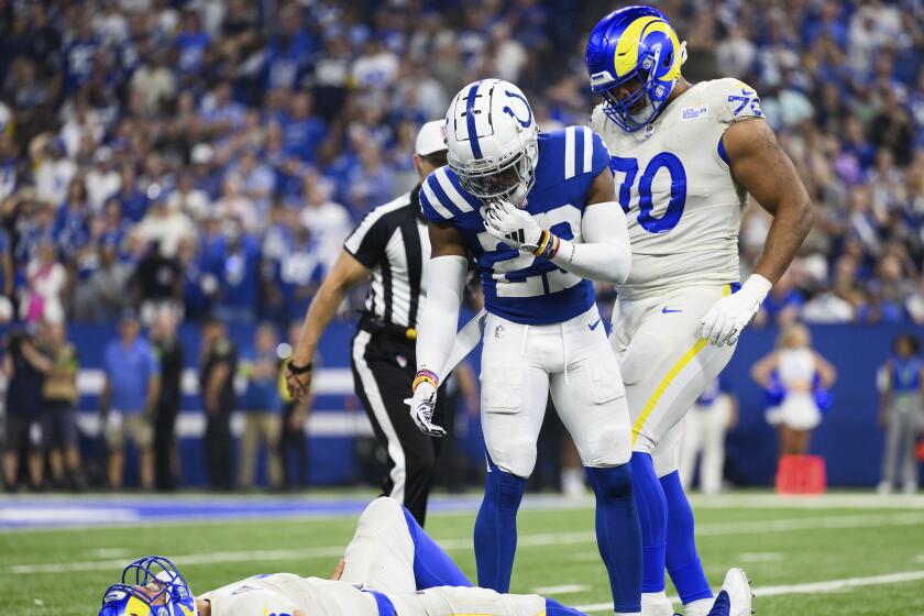  Colts cornerback Kenny Moore II (23) tries to help injured Rams quarterback Matthew Stafford.