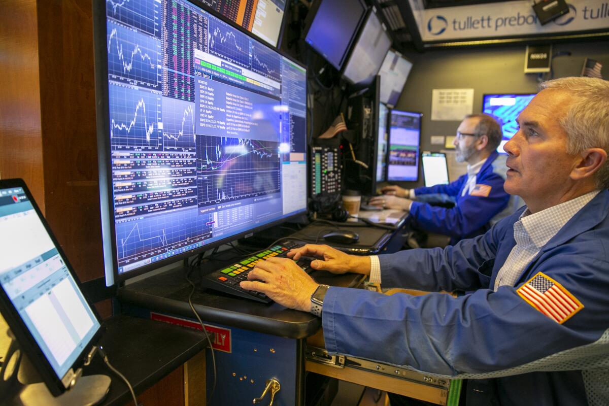 Traders work on the New York Stock Exchange floor