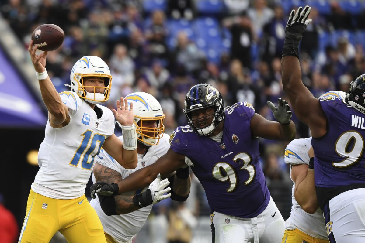 Qarterback Justin Herbert (10) throws a pass against the Ravens.