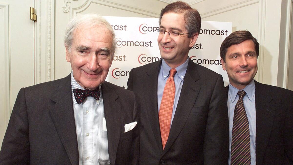 Comcast founder Ralph Roberts, left, CEO Brian Roberts and Steve Burke, now CEO of NBCUniversal, are shown in 2001.