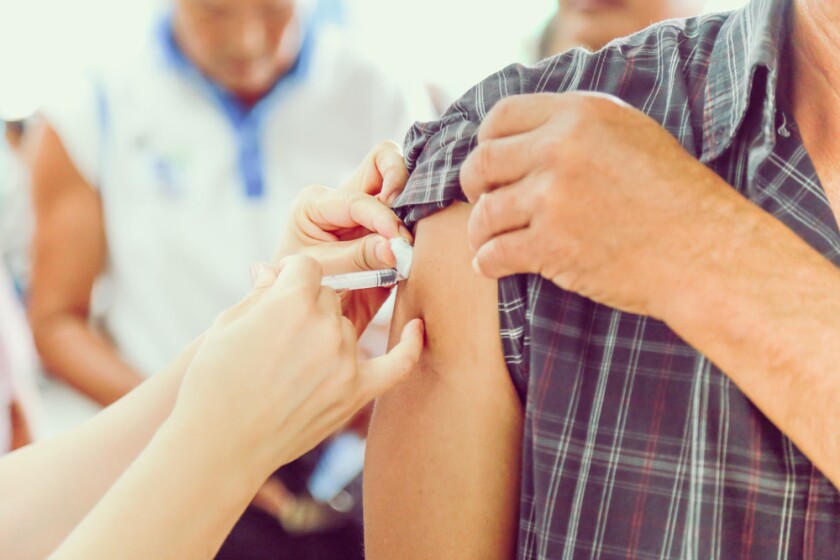 A person gets a needle injection in their arm.