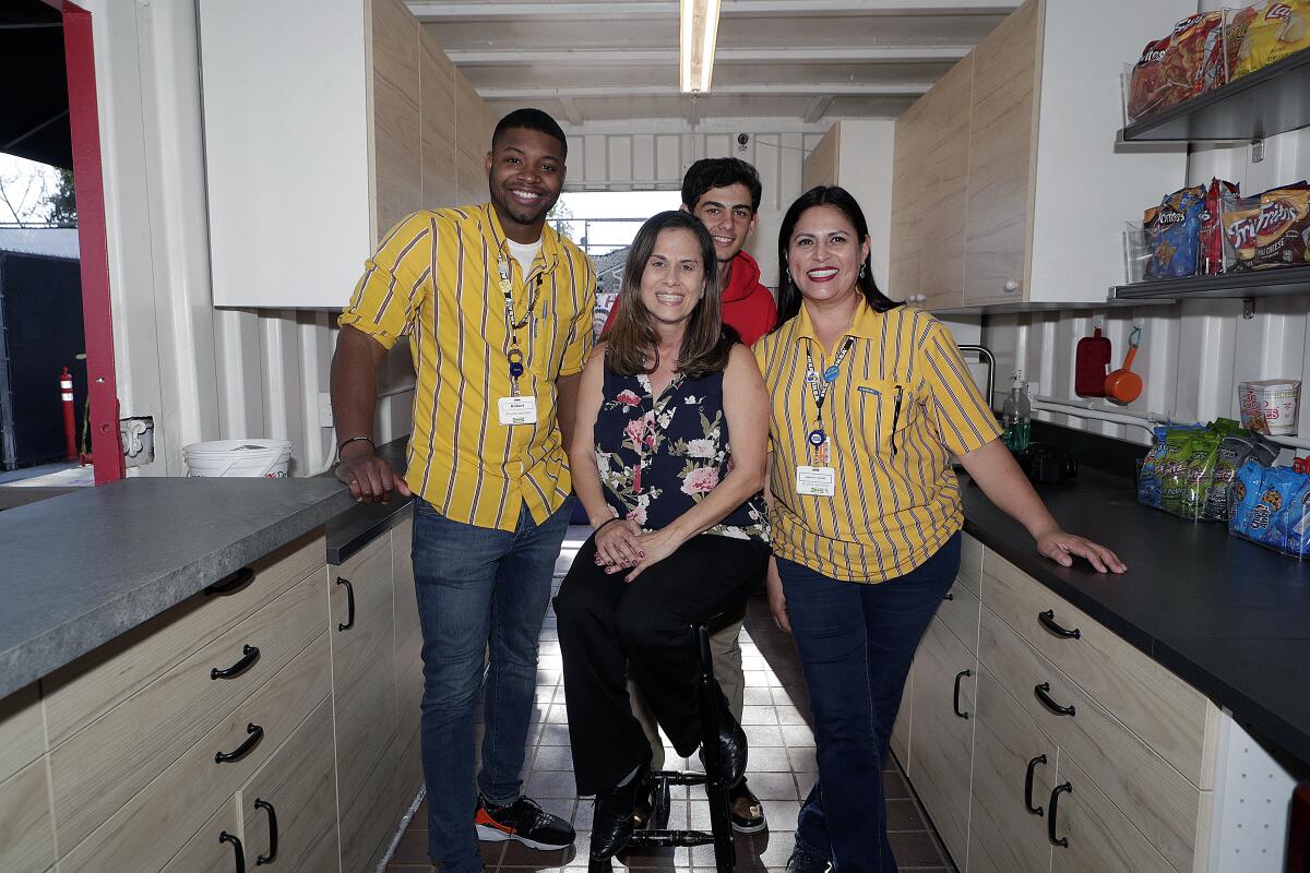 The remodel team, with Ikea Communication Event Specialist Robert Morgan, frosh baseball team parent Hilde Garcia, her son Sam Krol, 15, and Ikea Loyalty Manager Mary Ann Barroso-Castanon in the newly remodeled snack shack for Burroughs High School baseball.