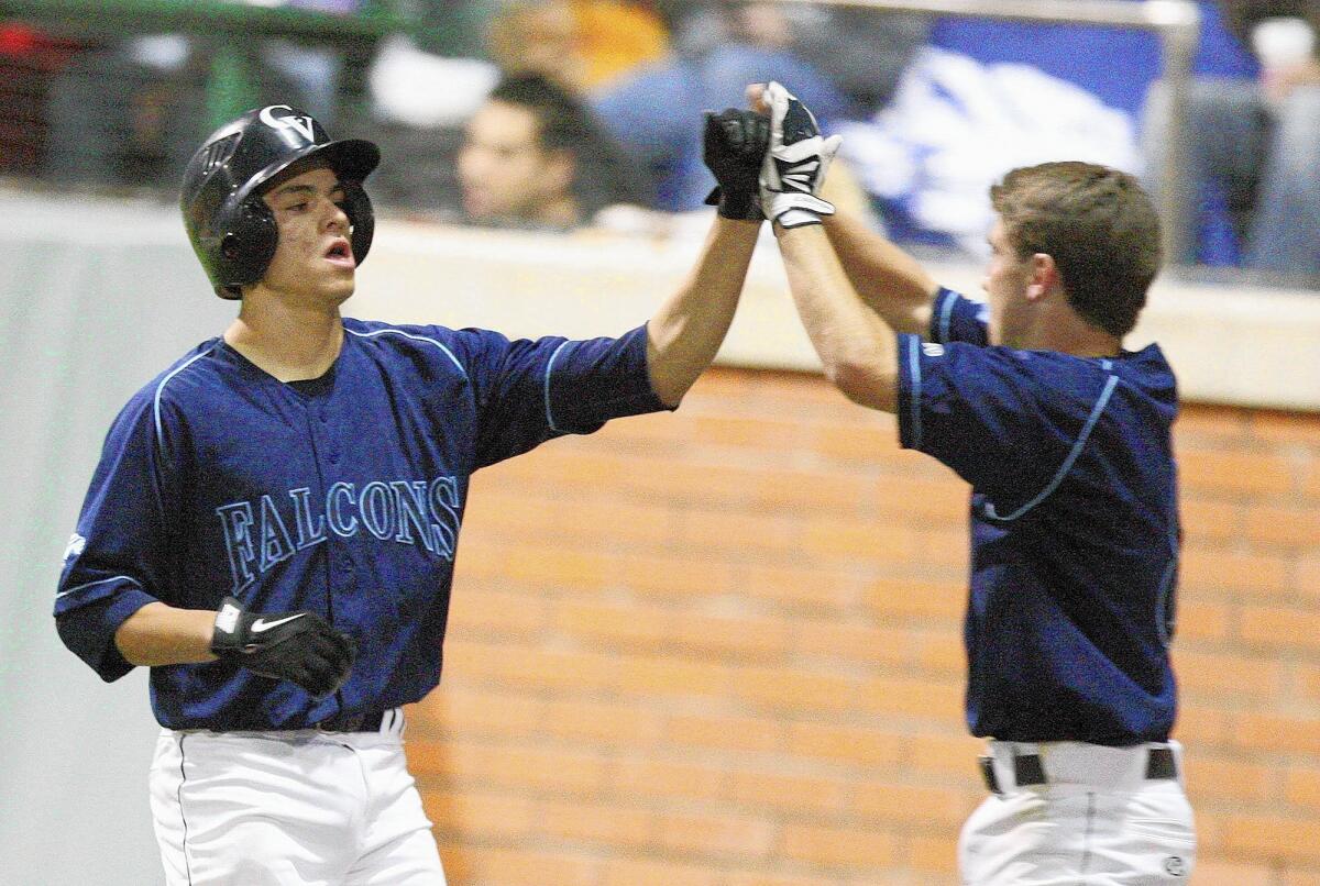 Crescenta Valley's Nick Diaz gets a high five from Joe Torres after scoring the second run against La Canada during a game at Stengel Field on Tuesday, March 4, 2014.