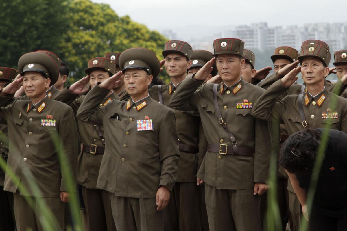 North Korean army officers and soldiers salute to show their respect to late North Korean leaders Kim Il Sung and Kim Jong Il on the 19th anniversary of Kim Il Sung's death.