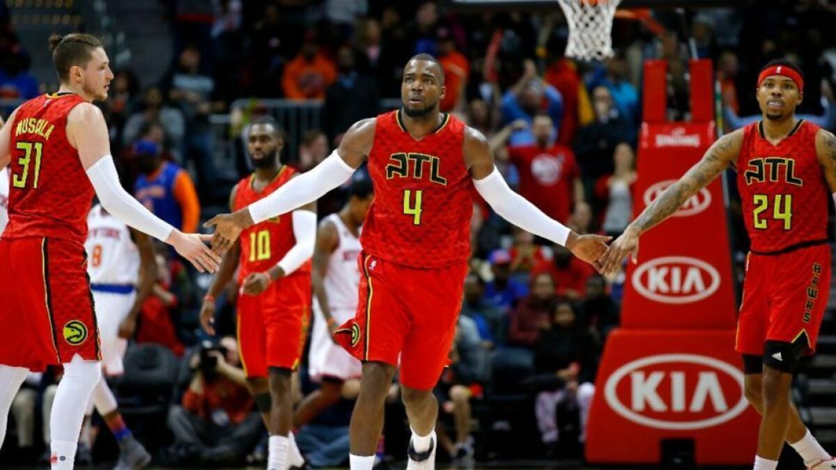 Hawks forward Paul Millsap (4) reacts with forward Mike Muscala (31) and forward Kent Bazemore (24) in the fourth overtime of a game against the Knicks on Jan. 29.