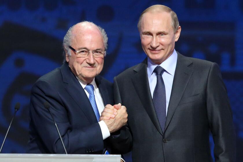 FIFA President Sepp Blatter, left, shakes hands with Russian President Vladimir Putin ahead of the preliminary draw for the 2018 World Cup qualifiers at the Konstantin Palace in St. Petersburg, Russia, on Saturday.