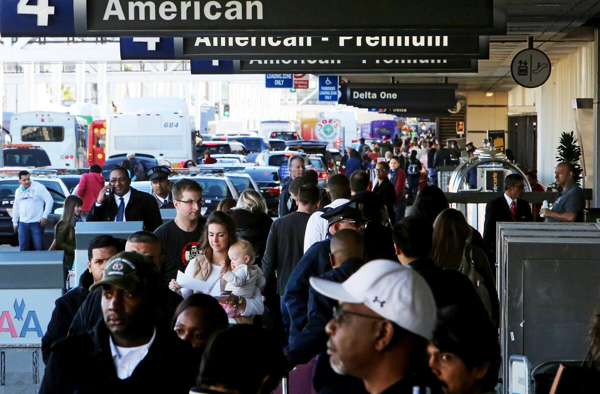 Travelers crowd the departure deck at Los Angeles International Airport on Nov. 25, 2105, the day before Thanksgiving. The nation's airlines set records for passenger traffic last year.