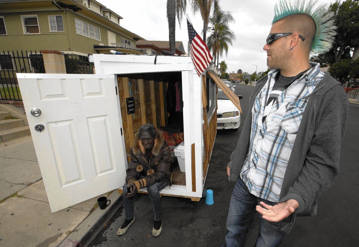 Los Angeles resident Elvis Summers, right, poses with the tiny house on wheels that he built for Irene "Smokie" McGhee, 60, a woman who had been sleeping on the streets in his South Los Angeles neighborhood, on May 7, 2015.