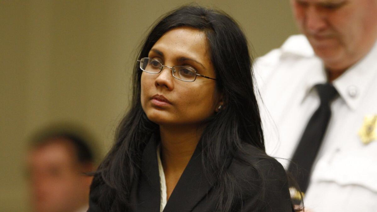 Annie Dookhan, a former chemist at the Hinton State Laboratory Institute, listens to the judge during her arraignment in Brockton, Mass.