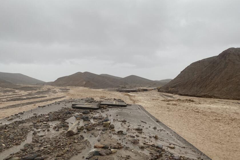 In this photo provided by the National Park Service, Mud Canyon Road is closed due to flash flooding in Death Valley, Calif., Friday, Aug. 5, 2022. Heavy rainfall triggered flash flooding that closed several Death Valley National Park roads on Friday near the California-Nevada line. The National Weather Service reported that all park roads had been closed after 1.46 inches of rain fell quickly. (National Park Service/Death Valley National Park via AP)