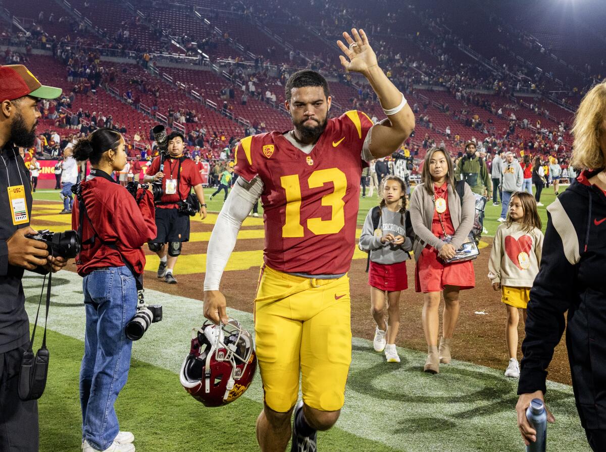 USC quarterback Caleb Williams waves to fans while leaving the field after the Trojans' 52-42 loss to Washington