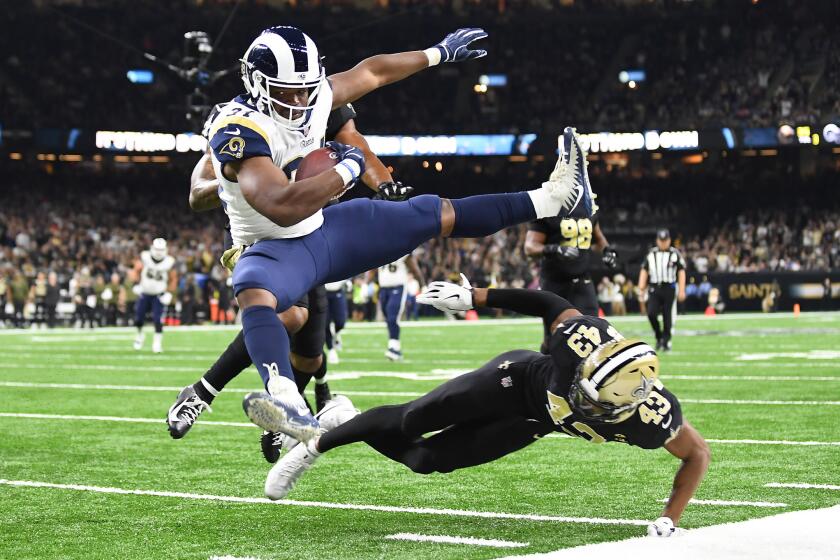 NEW ORLEANS, LOUISIANA, NOVEMBER 4, 2018-Rams running back Malcolm Brown leaps over Saints safety Marcus Williams to score a touchdown in the 3rd quarter at the Mercedes Benz Superdome in Louisiana Sunday. (Wally Skalij/Los Angeles Times)
