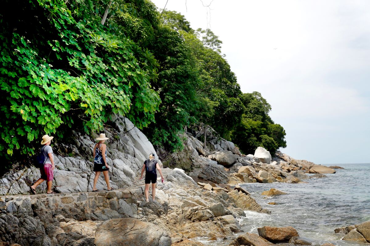 A trail that hugs the shore takes hikers from Boca de Tomatlán to Quimixto in Puerto Vallarta, Mexico.