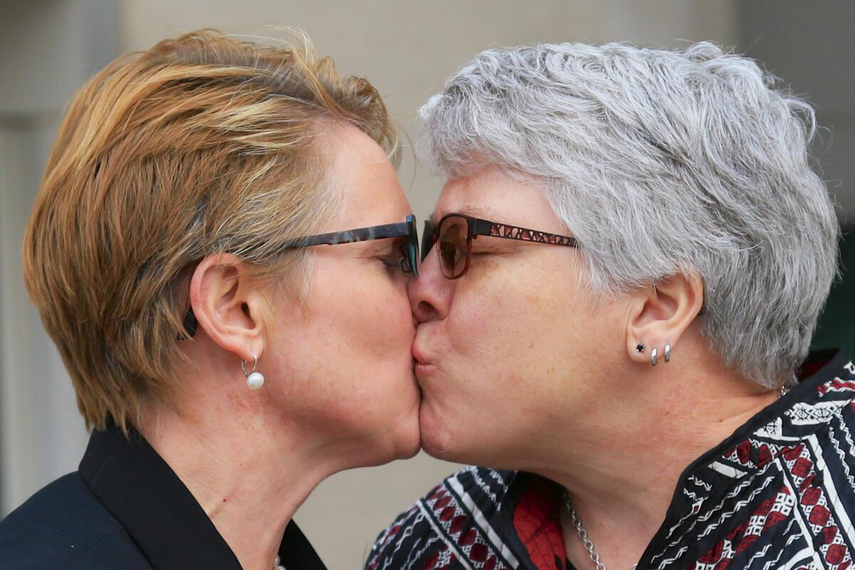 Tracy Weitz, left, and Marj Plumb kiss outside federal court in Omaha prior to a Feb. 19 hearing on the constitutionality of Nebraska's ban on same-sex marriage.