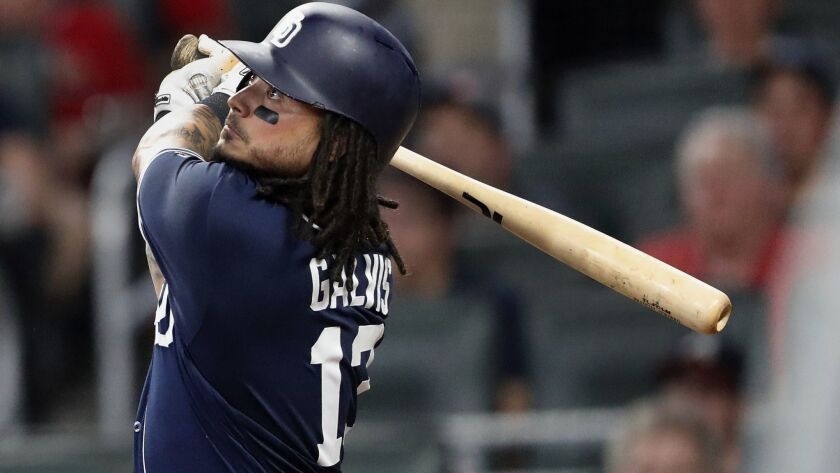 San Diego Padres shortstop Freddy Galvis follows through on a three-run home run in the seventh inning of a baseball game against the Atlanta Braves, Friday, June 15, 2018, in Atlanta.