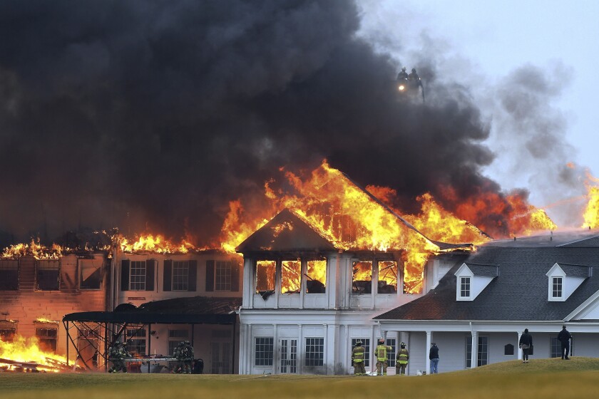 A fire burns at the main building at Oakland Hills Country Club in Bloomfield Township, Mich., on Thursday, Feb. 17, 2022. Firefighters battled a blaze at a more than century-old country club Thursday in suburban Detroit that's hosted several major golf tournaments and is one of Michigan’s most exclusive golf clubs.(Daniel Mears /Detroit News via AP)