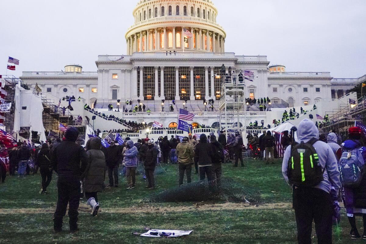 Rioters walk on the West Front at the U.S. Capitol on Jan. 6, 2021