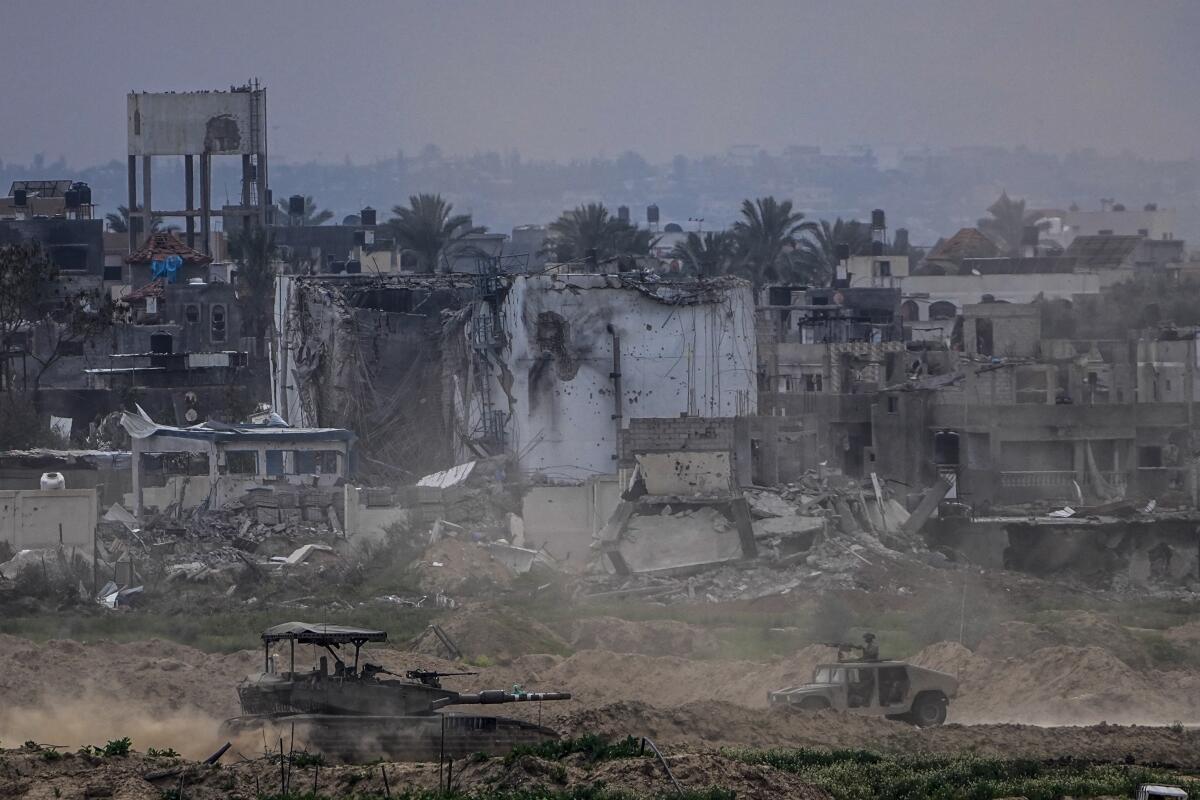 Destruction and Israeli soldiers inside the Gaza Strip, as seen from southern Israel.