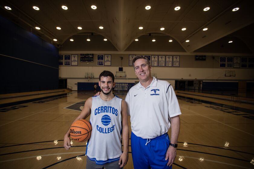 Norwalk, CA - March 07: Kade Weston, left, a deaf and autistic student athlete at Cerritos College, poses for a photo with coach Russ May, during practice at Cerritos College in Norwalk Tuesday, March 7, 2023. (Allen J. Schaben / Los Angeles Times) Kade lost his mother to cancer, and also lost a close family friend whom he called his second mother. Kade has an infectious spirit and camaraderie with the coach and team, is very dedicated and practices very hard.